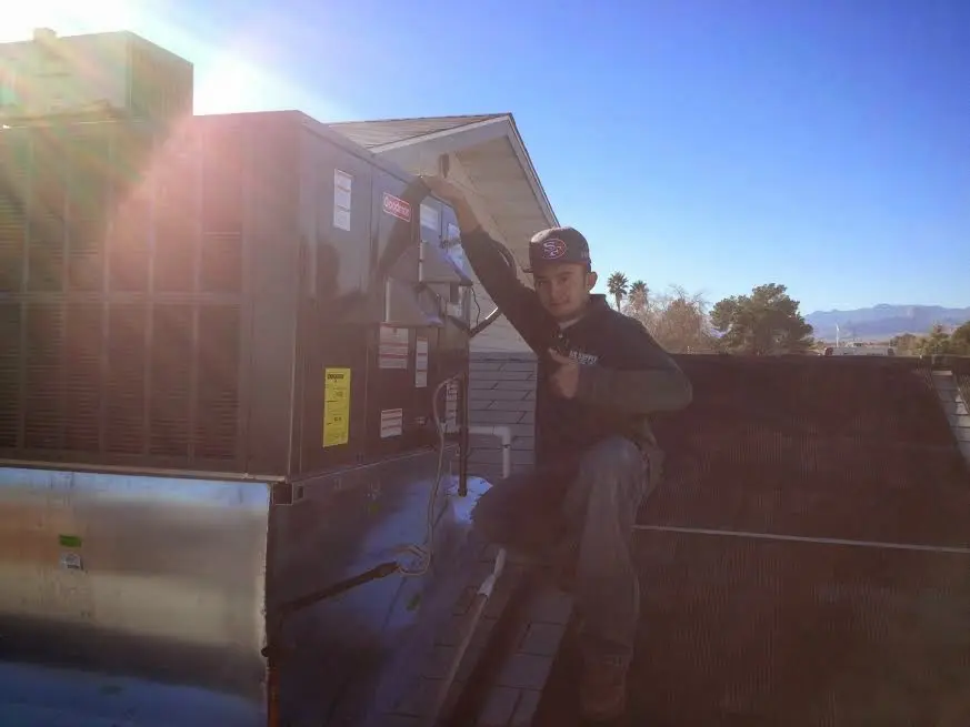 HVAC technician performing Air Duct Repair on a rooftop unit in South San Francisco